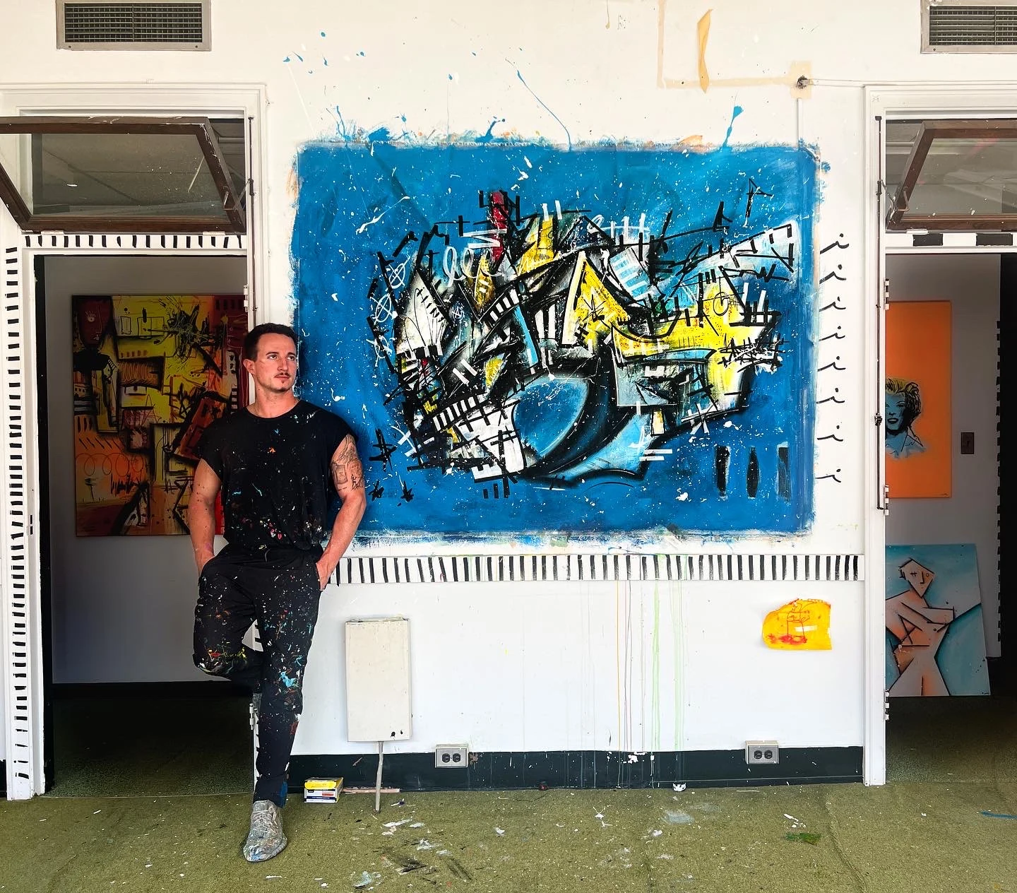Joe Taveras beside his painting From the Stars